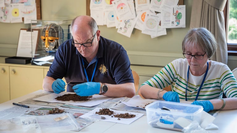Two people processing archaeological finds at Sutton Hoo, Suffolk
